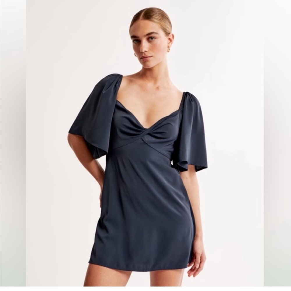 Navy blue mini dress with built in shorts, tie back, flutter sleeve